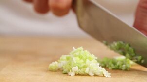 Spring onions being chopped