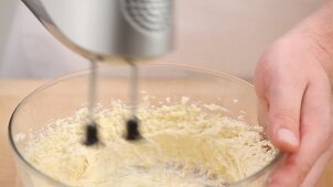 Dough being kneaded in a bowl with dough hooks
