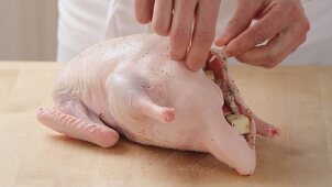 Duck being filled with onion and apple stuffing (German Voice Over)