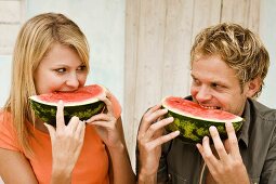 Young couple eating watermelon