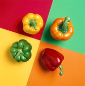 Four Assorted Bell Peppers on Colored Squares