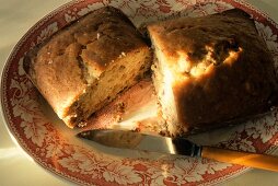 A Loaf of Cranberry Nut Bread Cut in Half; Knife