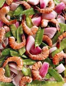 Pfannengerührte Shrimps mit Zwiebeln und Zuckerschoten (bildfüllend)