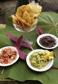 Crisps with various dips on banana leaf