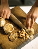 Pressing garlic cloves out of oven-baked garlic