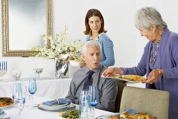 Women Bringing Hanukkah Meal to the Dining Table