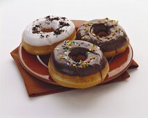 Drei Doughnuts mit Schokolade- und Vanilleglasur