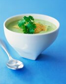 A Bowl of Avocado Soup on Blue Background