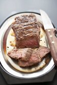 Partially Sliced Top Sirloin Streak on a Broiler Pan