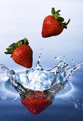 Strawberries falling into water