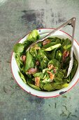 Spinach Salad with Warm Bacon Dressing in a Serving Bowl