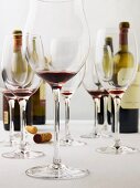 Several Almost Empty Wine Glasses; Wine Bottles