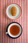 A Single Madeleine on a Plate with a Cup of Tea, From Above