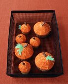 Decorated Pumpkin Cupcakes in a Wire Basket