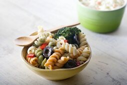 Small Bowl of Classic Pasta Salad with Wooden Spoon