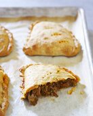 Empanadas on Baking Pan; One Broken Open