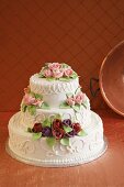 White Wedding Cake Decorated with Frosting Roses 