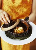 Woman Holding Pot au Feu with Sweet Chili Fish