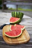 Slices of Watermelon on a Cutting Board on an Outdoor Table