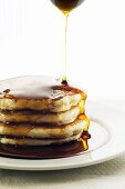 Maple Syrup Pouring Over a Stack of Pancakes