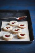 Jam Filled Heart Cookies on Paper on Pan