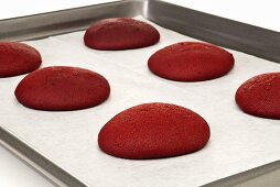 Gebackene Hälften von Red Velvet Whoopie Pies auf Backblech