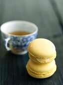 Two Lemon Macaroons; Stacked with a Cup of Tea