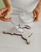 Decorating a Reindeer Shaped Christmas Cookie with Sugar