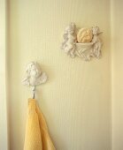 Angel figures and a towel hanging on the wall