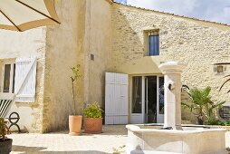 Southern architecture with a terrace and a stone fountain