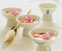 Pink rose petals in tea bowls with a calligraphy brush