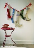 Fabric high-heels and socks hung of the wall for Father Christmas