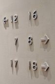 Numbers and arrows attached to a white wall