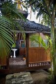 A view into an Asian-stlye palm house in the jungle