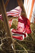 A towel, a red washbag and a pair of shoes on a ladder