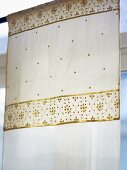 A curtain with gold embossing