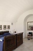 Vaulted ceiling in a bedroom with antique wooden beds