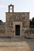 Romantic church with a weathered stone facade and a bell tower