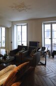 Black armchair in the living room of a villa with floor to ceiling windows