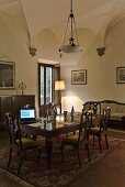 Vaulted ceiling in a dining room with antique table and chairs