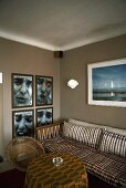 Living room corner with a sofa and photographs on a gray wall