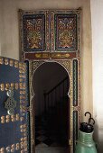 Oriental style painted door with a view of a stairway