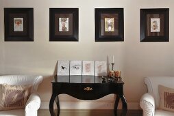 Black, shiny wall table in rococo style and a picture gallery