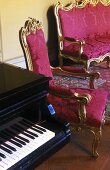 Rococo style furniture -- chair and bench with gilt frame and red upholstery next to a piano