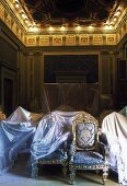 Restoring a room in a castle -- seating under protective covers in a hall