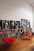 Red Bauhaus chairs in front of half-high bookshelves in a living room