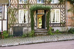 An old half-timbered house with an open front door