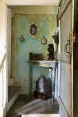 An open wooden door providing a view onto an old corner table