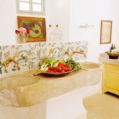 Food being prepared on a rustic stone sink in a kitchen in a Spanish country house