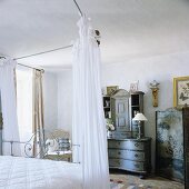 An antique chest of drawers with an attachment in a bedroom in a country house